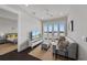 Neutral living room with balcony, hardwood floors, and ceiling fan at 624 N Point Dr, Holmes Beach, FL 34217
