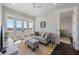 Comfortable living room with a gray sofa, stylish decor, and French doors to the balcony at 624 N Point Dr, Holmes Beach, FL 34217