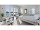 Bright main bedroom with water view, and access to private patio through sliding glass doors at 624 N Point Dr, Holmes Beach, FL 34217