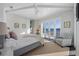 Bright main bedroom with water view, and access to private patio through sliding glass doors at 624 N Point Dr, Holmes Beach, FL 34217