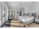 Bright main bedroom with water view, and access to private patio through sliding glass doors at 624 N Point Dr, Holmes Beach, FL 34217