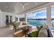 Covered patio featuring a seating area with pool and waterfront views at 624 N Point Dr, Holmes Beach, FL 34217