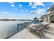 Spacious tiled patio with lounge chairs overlooking the harbor at 624 N Point Dr, Holmes Beach, FL 34217