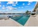 Beautiful pool with lounge chairs, palm trees, and harbor views at 624 N Point Dr, Holmes Beach, FL 34217