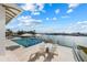 Relaxing poolside with comfortable seating and scenic water views, a true outdoor oasis and great view at 624 N Point Dr, Holmes Beach, FL 34217