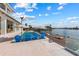Stunning pool area with waterfront access and ample seating, perfect for outdoor entertaining with a beautiful view at 624 N Point Dr, Holmes Beach, FL 34217