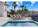Stunning outdoor pool area featuring comfortable lounge chairs and beautiful palm trees at 624 N Point Dr, Holmes Beach, FL 34217