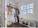 Walk-in closet with custom shelves, hanging rods, storage bench and window at 624 N Point Dr, Holmes Beach, FL 34217