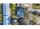 High angle showing the property's backyard, patio area, and mature trees surrounding the house at 7272 Cass Cir, Sarasota, FL 34231