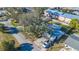 Aerial view of property surrounded by mature trees with driveway and car visible at 7272 Cass Cir, Sarasota, FL 34231