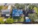 Aerial view of a home with a large backyard, patio, and proximity to neighboring houses at 7272 Cass Cir, Sarasota, FL 34231