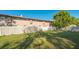 Fenced backyard with lush lawn and mature trees provides privacy at 7272 Cass Cir, Sarasota, FL 34231