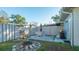 Cozy backyard patio area with a fire pit and a grill, perfect for outdoor entertaining at 7272 Cass Cir, Sarasota, FL 34231