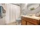 Bright bathroom featuring a wood vanity, tile flooring and stylish mirror detail at 7272 Cass Cir, Sarasota, FL 34231