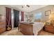 This cozy bedroom features stylish curtains, a ceiling fan, and a decorative guitar at 7272 Cass Cir, Sarasota, FL 34231