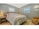 Comfortable bedroom with neutral colors and natural light from the two bright windows at 7272 Cass Cir, Sarasota, FL 34231