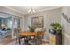 Charming dining room with a round table, decorative chairs, and a modern microwave on a wooden stand at 7272 Cass Cir, Sarasota, FL 34231
