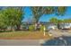 Charming single-story home with mature trees, manicured lawn, and a classic American mailbox at 7272 Cass Cir, Sarasota, FL 34231