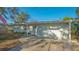Well-maintained single-story home with landscaped front yard and attached garage at 7272 Cass Cir, Sarasota, FL 34231