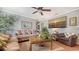 Comfortable living room with a ceiling fan, a large beach-themed picture, and comfortable couches at 7272 Cass Cir, Sarasota, FL 34231