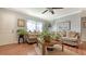 Cozy living room featuring wood-look floors, neutral walls, and comfortable couches with decorative pillows at 7272 Cass Cir, Sarasota, FL 34231