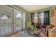 Living room with stylish furnishings, and natural light from the French doors to the yard at 7272 Cass Cir, Sarasota, FL 34231