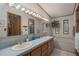 Bathroom features a double sink vanity and a soaking tub, with decorative light fixtures and wall decor at 8449 Imperial Cir, Palmetto, FL 34221
