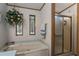 Bathroom boasts a soaking tub with wall decor, and a glass-door shower, offering a spa-like experience at 8449 Imperial Cir, Palmetto, FL 34221