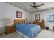 Bedroom with a large window, bedside tables with lamps and wood furniture at 8449 Imperial Cir, Palmetto, FL 34221