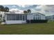 Beautiful home with screened-in porch and manicured lawn in a friendly community at 8449 Imperial Cir, Palmetto, FL 34221