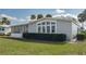 Well-maintained home with a screened-in porch, pristine lawn, and lush shrubbery in a tranquil community at 8449 Imperial Cir, Palmetto, FL 34221
