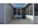 Home exterior showing the entrance to the screened-in porch, with stone path and low maintenance yard at 8449 Imperial Cir, Palmetto, FL 34221