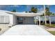 Charming single-story home featuring a covered carport, front door, and well-maintained landscaping at 8449 Imperial Cir, Palmetto, FL 34221