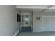 Close up of the front door, featuring glass accents and the front entrance with a white handrail at 8449 Imperial Cir, Palmetto, FL 34221