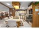 Bright kitchen featuring an island cooktop, white appliances, and wood cabinetry with floral wallpaper accents at 8449 Imperial Cir, Palmetto, FL 34221