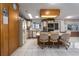 Bright kitchen featuring an island cooktop, white appliances, and wood cabinetry with floral wallpaper accents at 8449 Imperial Cir, Palmetto, FL 34221