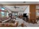 Bright living room featuring many windows with a waterfront view, ceiling fan, and wicker furnishings at 8449 Imperial Cir, Palmetto, FL 34221