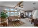 Bright living room featuring many windows with a waterfront view, a ceiling fan, and a desk space at 8449 Imperial Cir, Palmetto, FL 34221