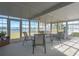 Bright sunroom with water view, features a dining set, perfect for enjoying meals and scenic views at 8449 Imperial Cir, Palmetto, FL 34221