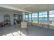 Bright sunroom with water view, features a dining set, perfect for enjoying meals and scenic views at 8449 Imperial Cir, Palmetto, FL 34221