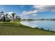 Expansive water view with lush green landscaping, a variety of birds, and serene community lakeside at 8449 Imperial Cir, Palmetto, FL 34221