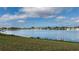 Picturesque water view showcases community lake with lush green shoreline and diverse wildlife at 8449 Imperial Cir, Palmetto, FL 34221