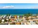 An aerial shows the home's proximity to the beach and highlights the surrounding vibrant community at 912 N Shore Dr, Anna Maria, FL 34216
