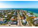 A high aerial shows a coastal community with beautiful, clear gulf waters and sandy beaches at 912 N Shore Dr, Anna Maria, FL 34216