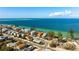 An aerial view features the home, community and white sand gulf beaches that are just steps away at 912 N Shore Dr, Anna Maria, FL 34216