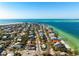 High aerial shot of a neighborhood by the water's edge near pristine beaches on a barrier island at 912 N Shore Dr, Anna Maria, FL 34216