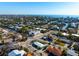 Aerial view showcasing home in coastal community with mature trees and water views in the distance at 912 N Shore Dr, Anna Maria, FL 34216