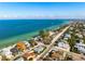 Expansive aerial view of the home near the beach and turquoise waters in a beautiful coastal community at 912 N Shore Dr, Anna Maria, FL 34216