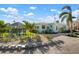 Exterior of a charming beach home that features a gazebo and well-manicured backyard at 912 N Shore Dr, Anna Maria, FL 34216