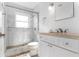 Bathroom with updated shower, marble tile, modern vanity and new fixtures at 912 N Shore Dr, Anna Maria, FL 34216
